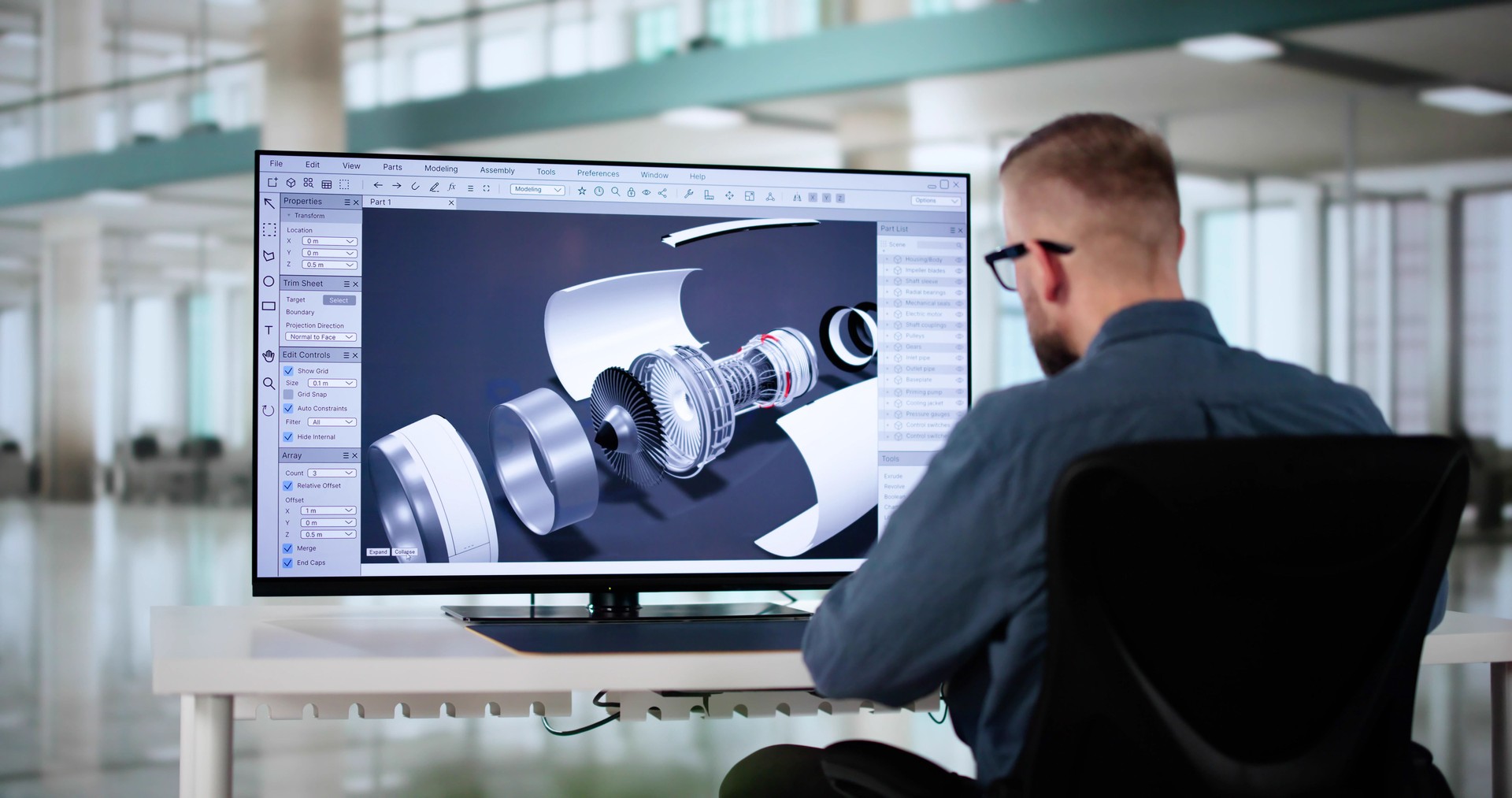 Male Engineer Developing Mechanical Parts Using 3D CAD Software On Laptop